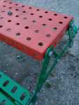 Showing the 10x-scaled pieces of Meccano and bolts